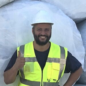 A person in a yellow safety vest posing with a "thumb's up".