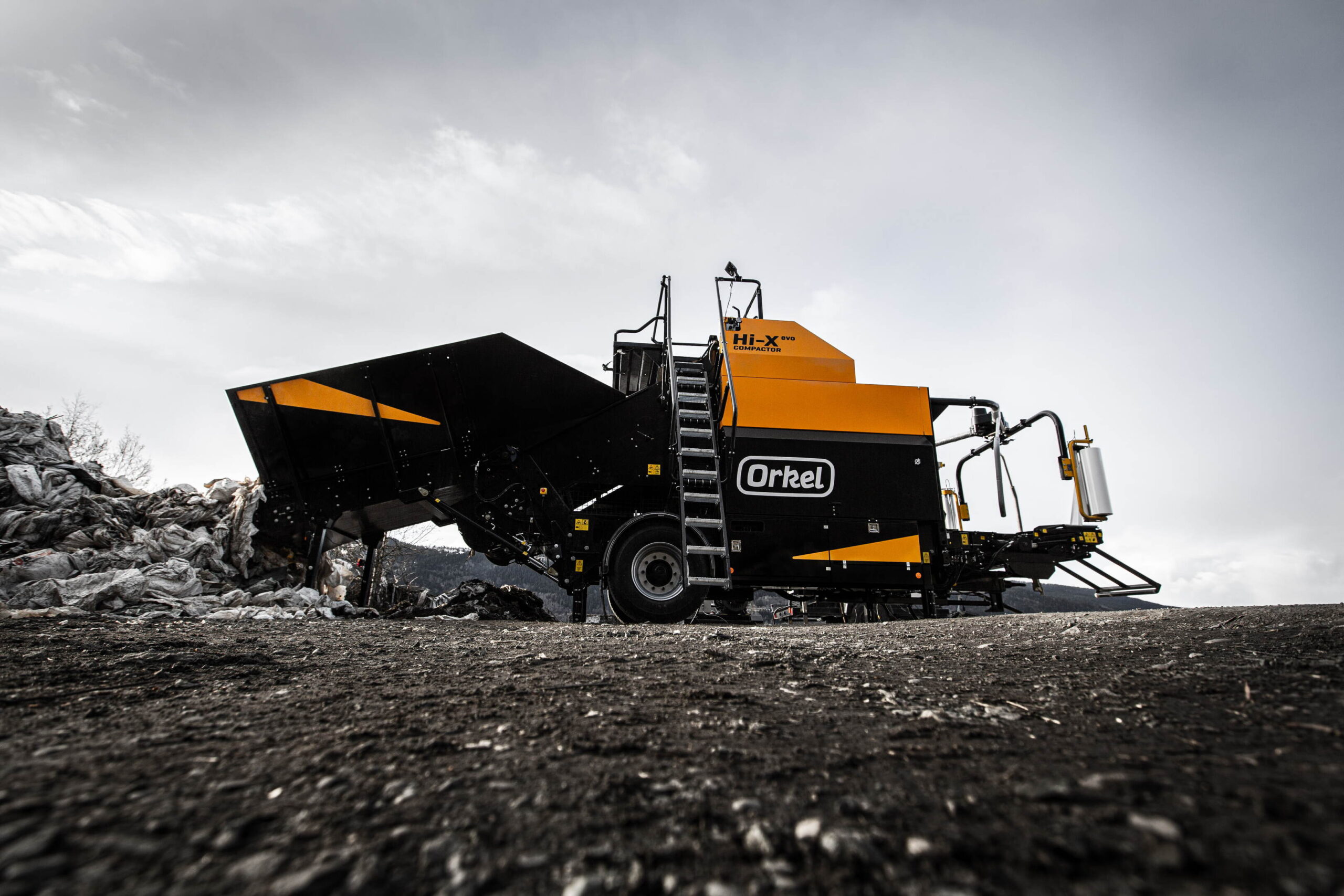 A Hi-X evo compactor shot from below, with a grey flooring and white skies.