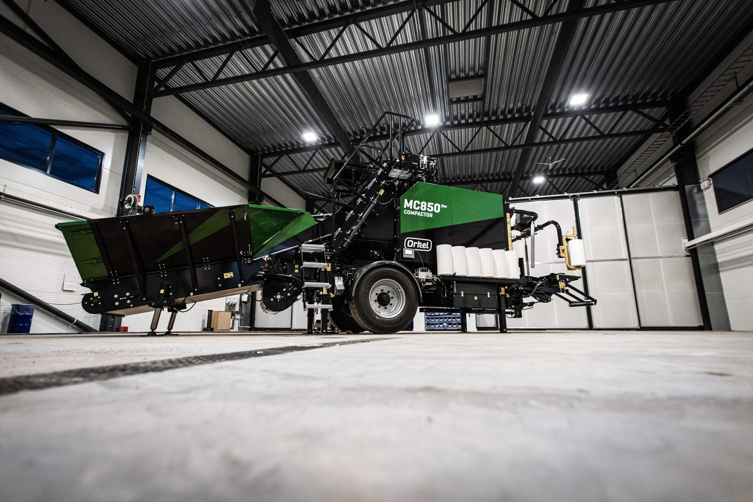 An MC850 flex compactor in concrete and steel facilities shot from below.