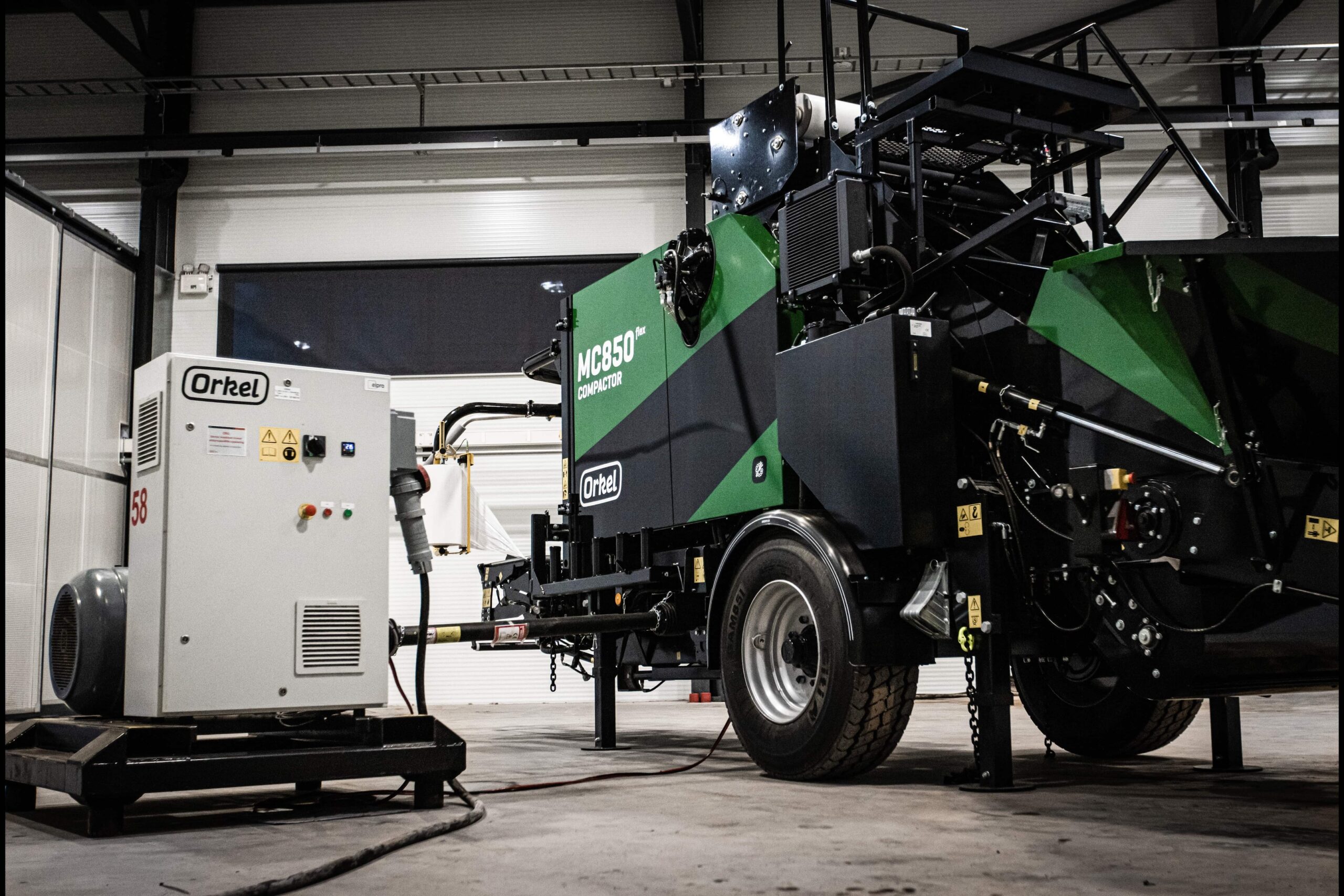 An MC850 flex compactor in concrete and steel facilities next to an Orkel Powerpack.