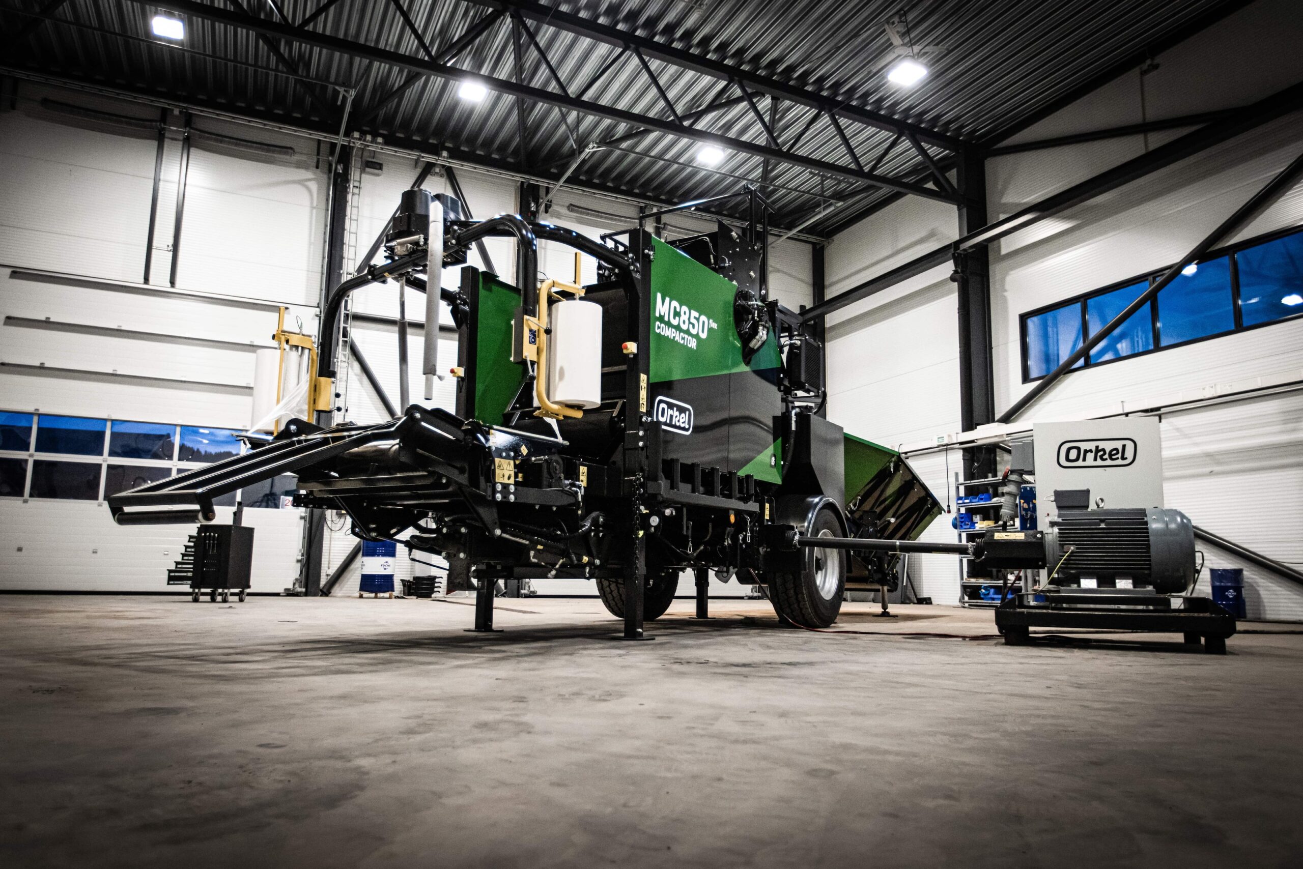 An MC850 flex compactor in concrete and steel facilities shot from below.