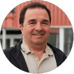 Portrait of a man standing in front of a red building