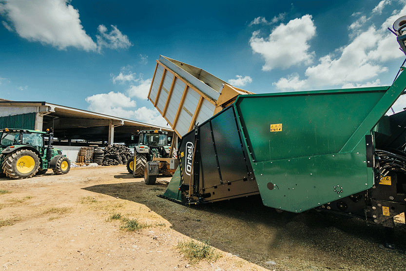 F25 feed hopper and a trailer loading material into it